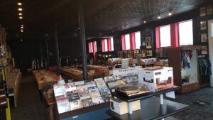 Interior shot of Pizza Records' big space with many music-related products for sale, including turntable and vinyl records.
